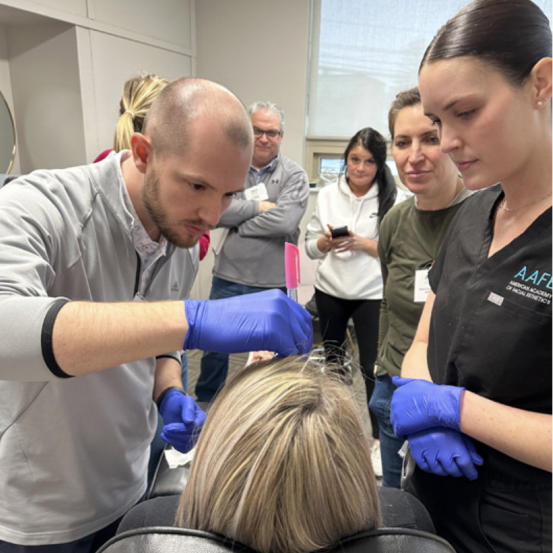 AAFE faculty guiding a dentist through a live patient consultation